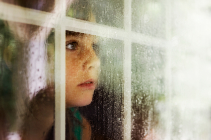 8_boy-looking-out-window-in-the-rain.