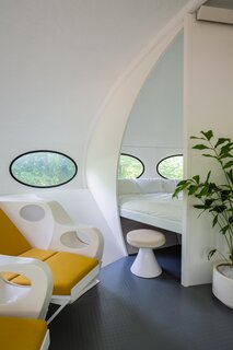 a-private-sleeping-nook-is-located-around-off-the-open-plan-living-spaces.