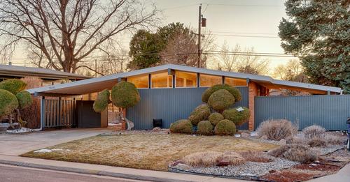 ectural-language-of-vertical-plywood-siding-and-brick-combined-with-an-oversize-roof-kinney-says.