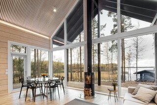 uge-windows-connect-indoors-with-out-a-wood-burning-fireplace-centers-the-living-and-dining-area.